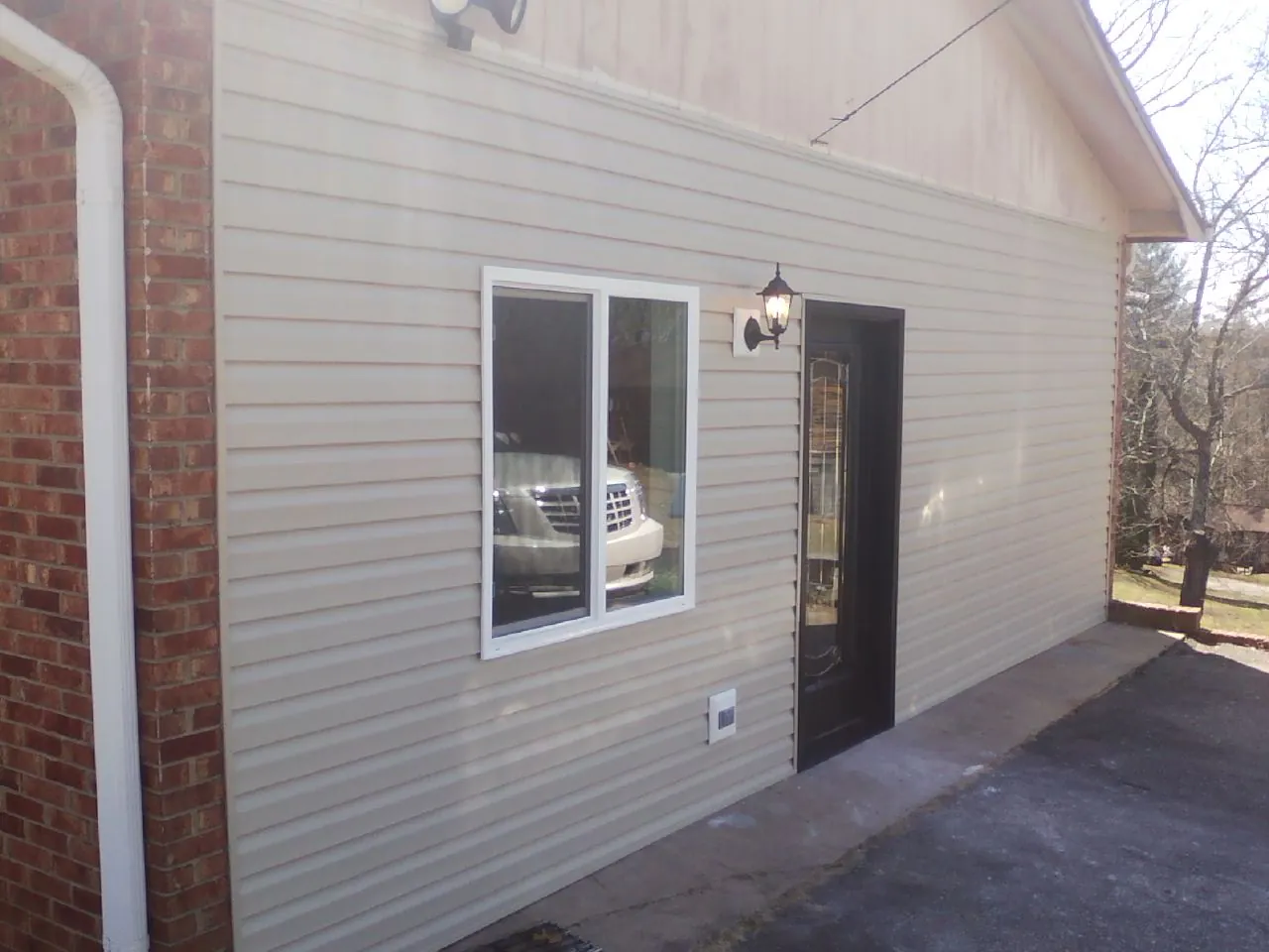 New vinyl siding and entry door on a room addition in Dillard
