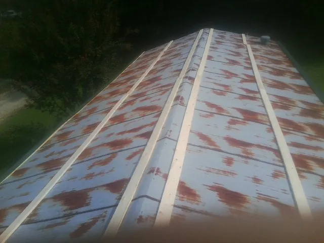 Rusted metal roof panels with new wood purlins before replacement — Storm Damage Roof Repair in Dillard by Roofing Brothers